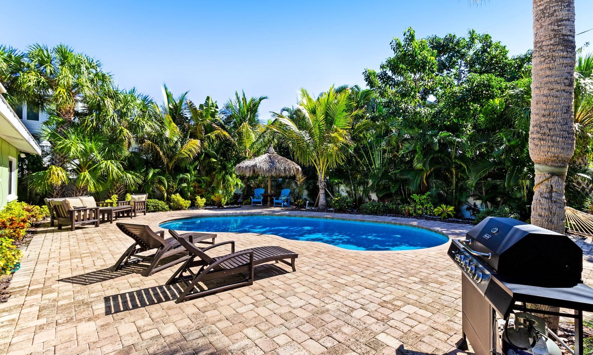 Holmes Beach House | Tropical-themed getaway w/heated private pool - walk to free trolley, shopping