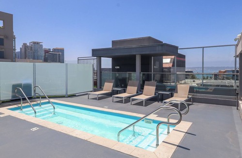 Little Italy Hotel | Deluxe 2 Queens: Pillow-Top Beds + Sitting Area | Rooftop Pool Access