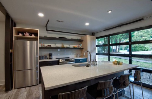 Charlotte House | Luxurious Guest House Retreat in Lower South End w/retractable glass garage door