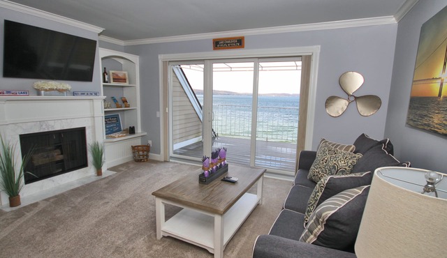 Vaulted Ceilings + Prime Lake Charlevoix Views | Fireplace | Private Patio|